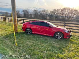 Red Honda Civic struck the pole